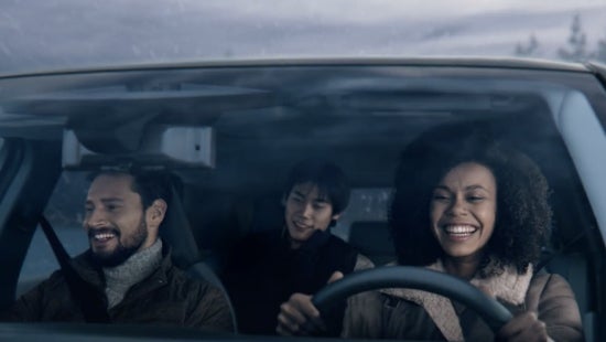 Three passengers riding in a vehicle and smiling | LOUGHEAD NISSAN in Swarthmore PA