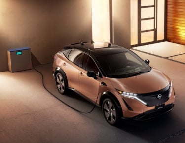 Nissan ARIYA plugged-in and charging outside a home | LOUGHEAD NISSAN in Swarthmore PA