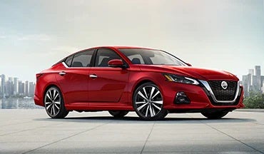 2023 Nissan Altima in red with city in background illustrating last year's 2022 model in LOUGHEAD NISSAN in Swarthmore PA